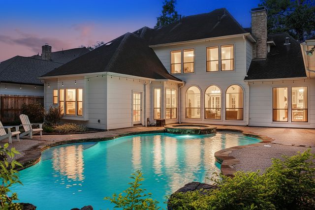 a view of a couches and a fire pit in the backyard