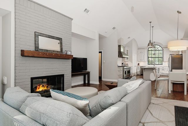 a living room with furniture fireplace and flat screen tv