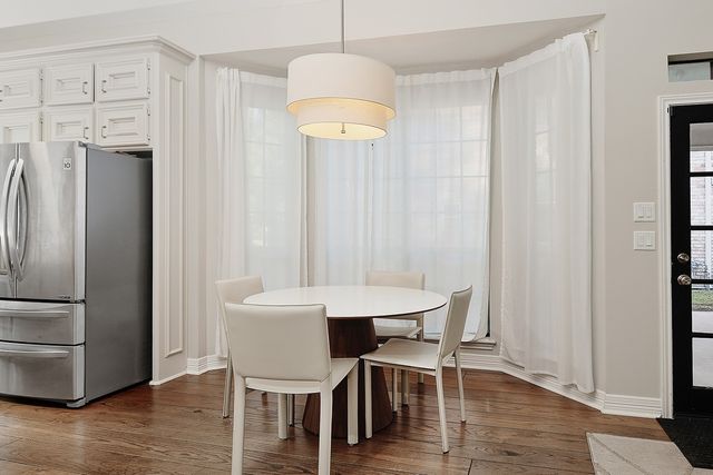 a view of a dining room with furniture window and wooden floor