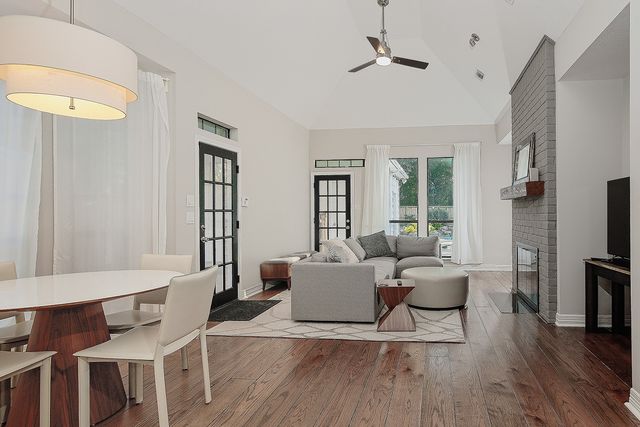 a living room with fireplace furniture and a flat screen tv