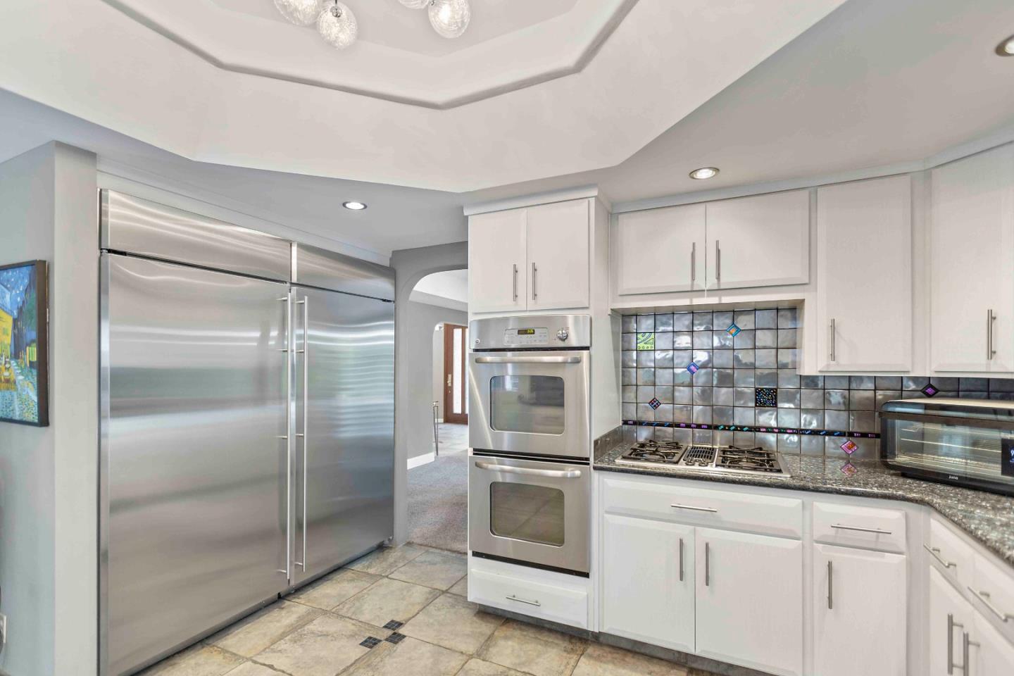 23491 Summit Road Los Gatos, CA 95033 - Photo 18 of 77 a kitchen with stainless steel appliances a refrigerator sink and cabinets