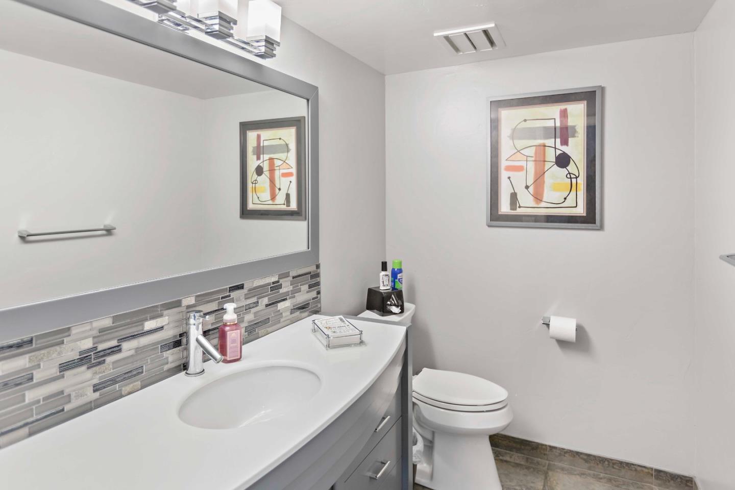 23491 Summit Road Los Gatos, CA 95033 - Photo 21 of 77 a bathroom with a toilet a sink and mirror