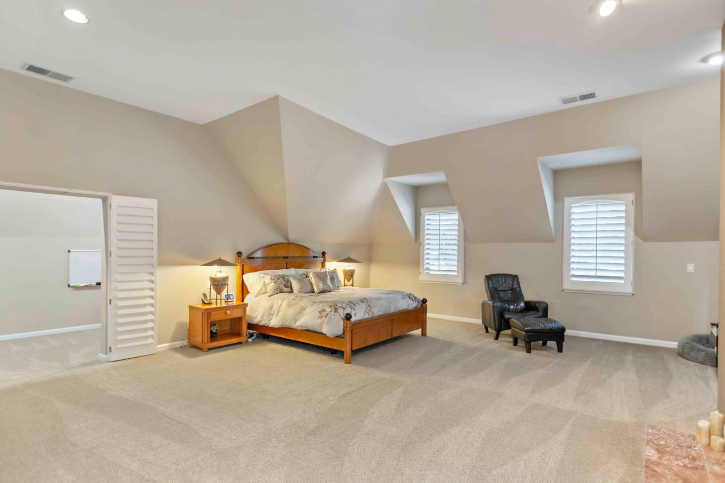 23491 Summit Road Los Gatos, CA 95033 - Photo 40 of 77 a spacious bedroom with a bed and a couch