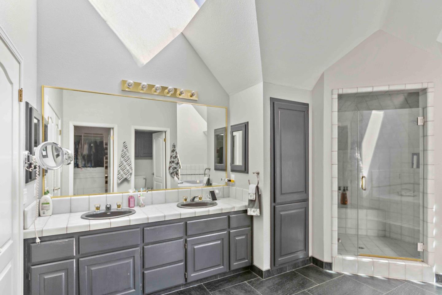 23491 Summit Road Los Gatos, CA 95033 - Photo 44 of 77 a spacious bathroom with a shower sink and mirror