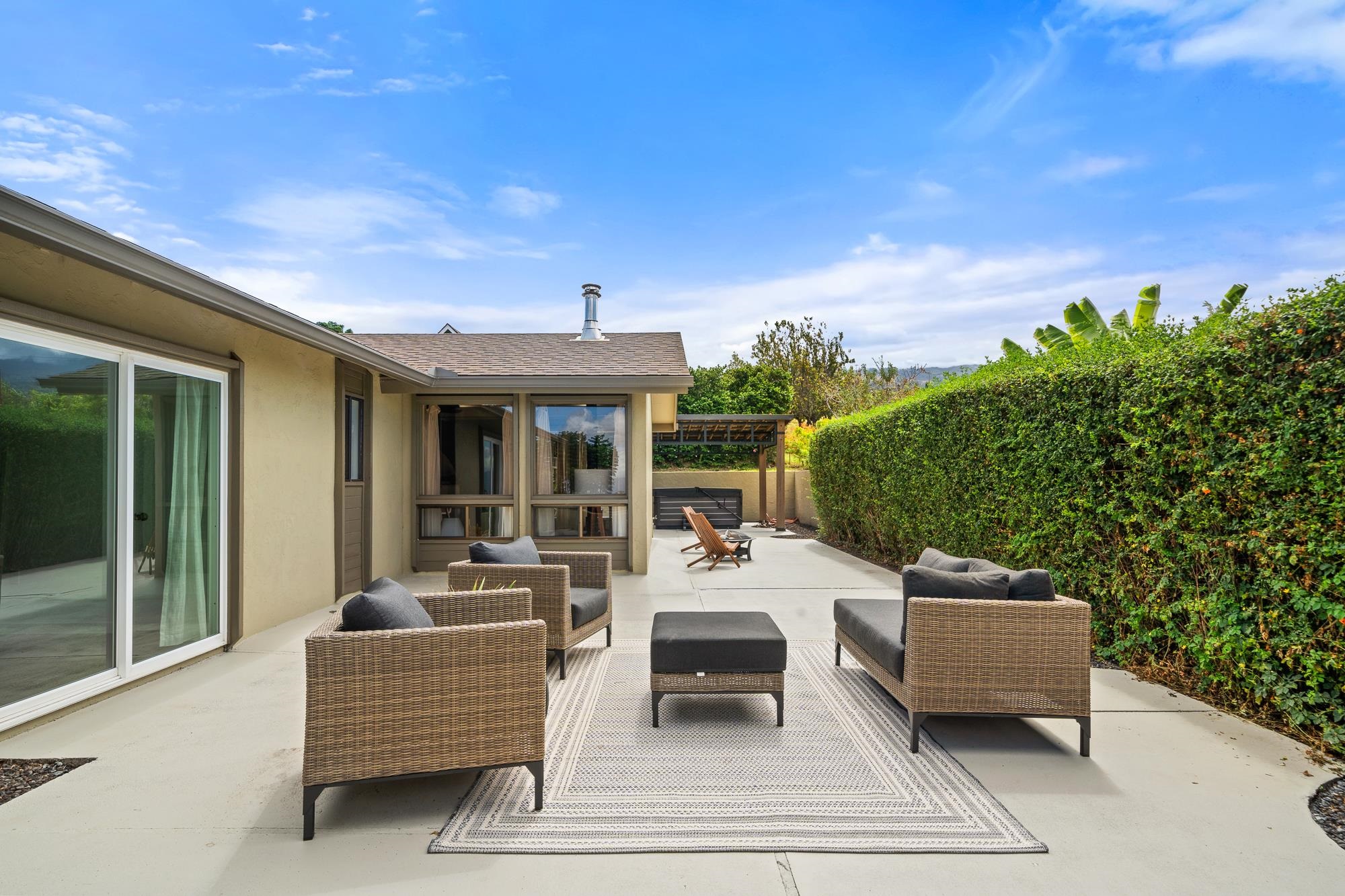 84 Mano Drive Kula, HI 96790 - Photo 23 of 25 a view of a patio with couches and table and chairs and potted plants