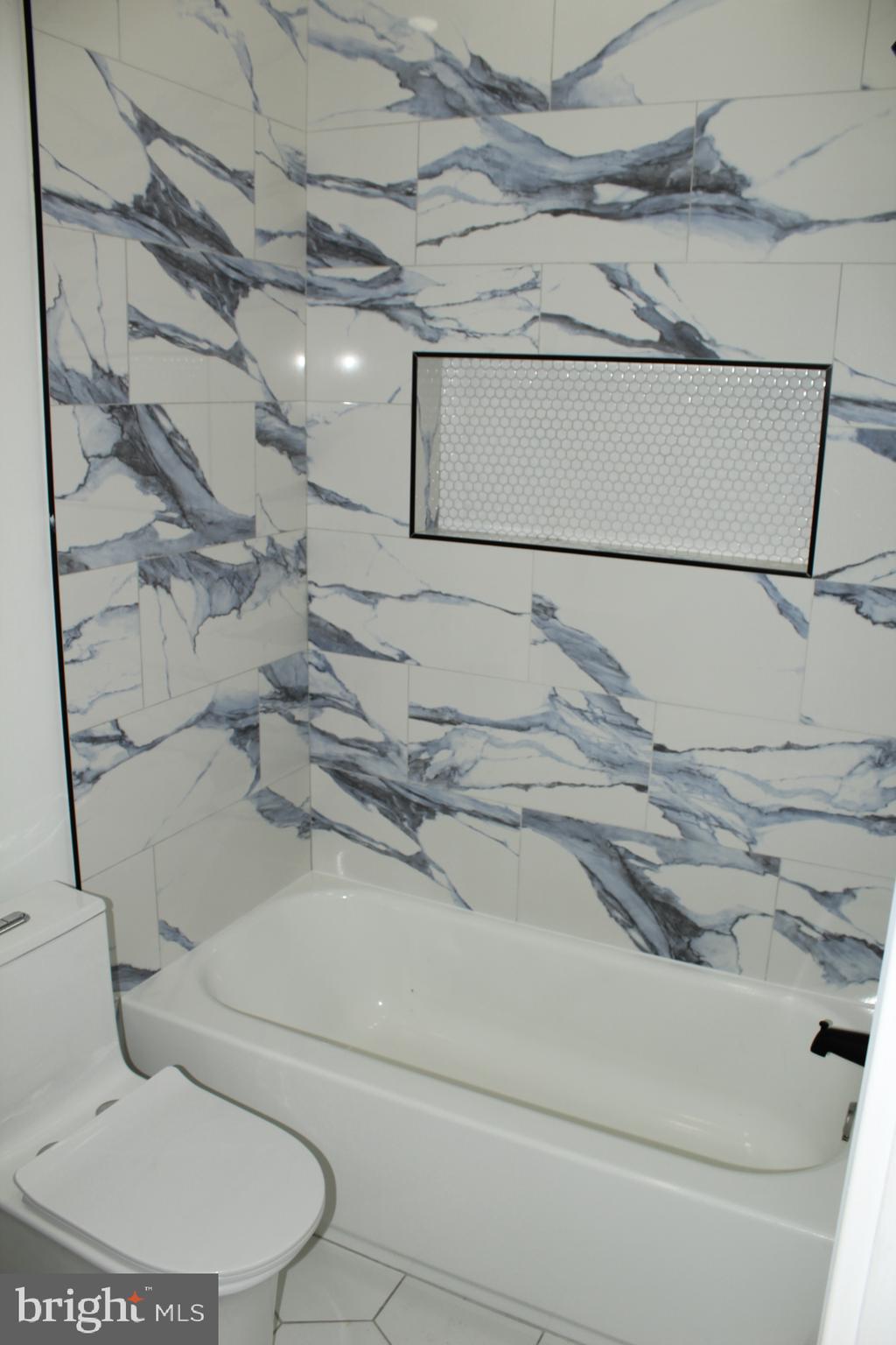 3017 Ridge Avenue, Unit C Philadelphia, PA 19121 - Photo 18 of 27 Elegant marble-patterned bathroom retreat.