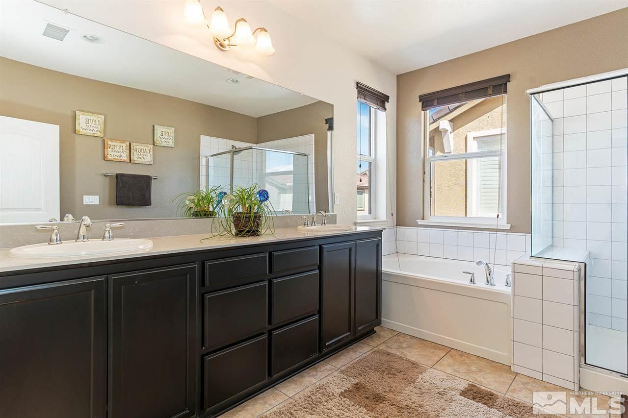1965 Hope Valley Drive Reno, NV 89521 - Photo 9 of 17 a bathroom with a double vanity sink bathtub and next to a window
