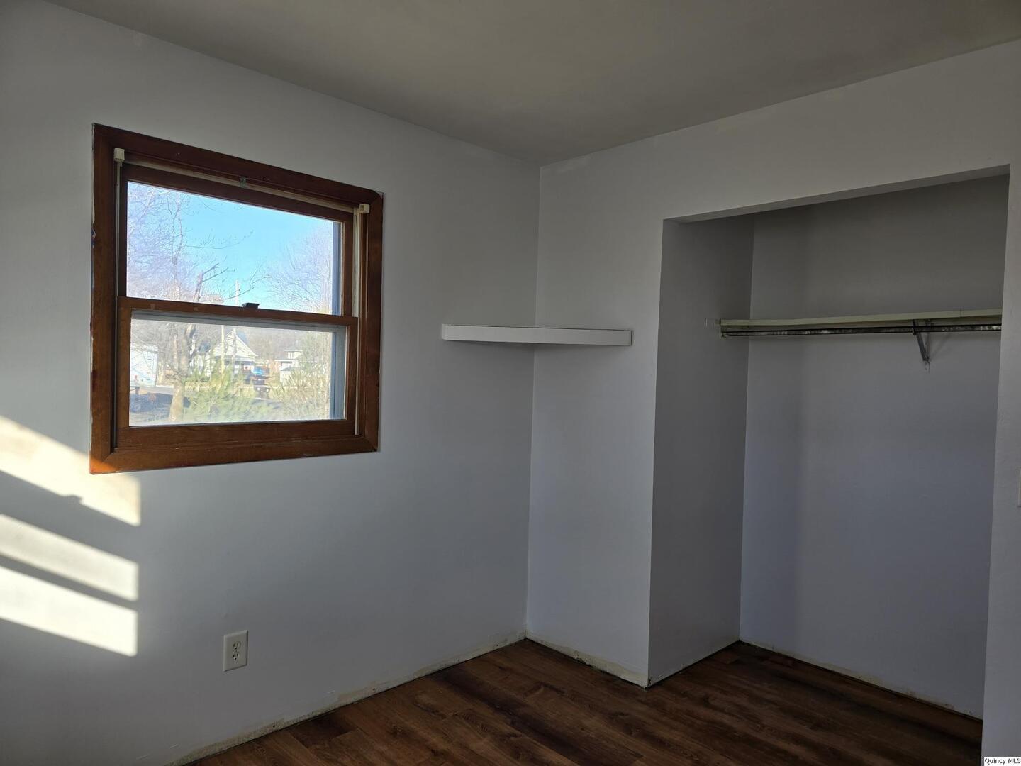 305 East 3rd Street Bowen, IL 62316 - Photo 11 of 32 a view of an empty room with wooden floor and a window
