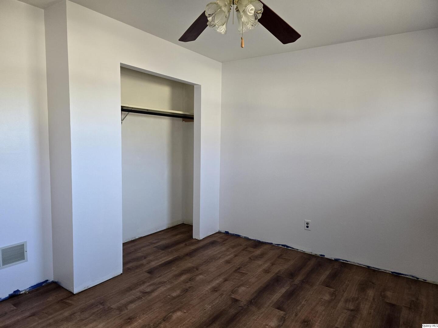 305 East 3rd Street Bowen, IL 62316 - Photo 13 of 32 an empty room with wooden floor cabinet and a ceiling fan