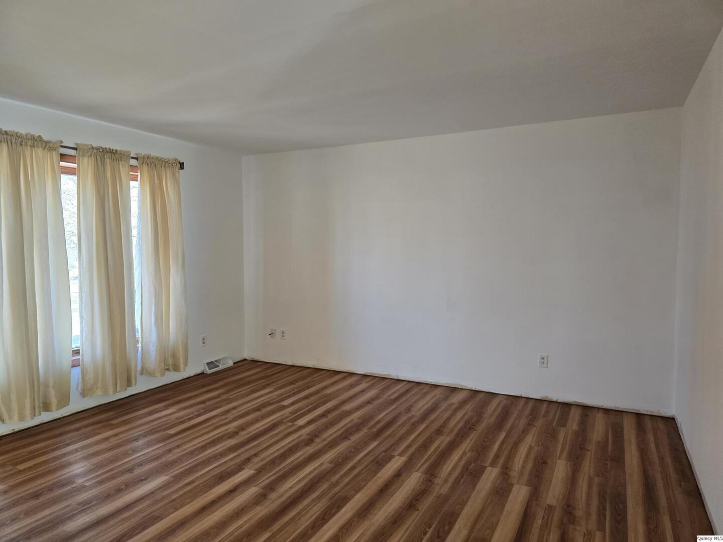 305 East 3rd Street Bowen, IL 62316 - Photo 2 of 32 a view of a room with wooden floor and fence