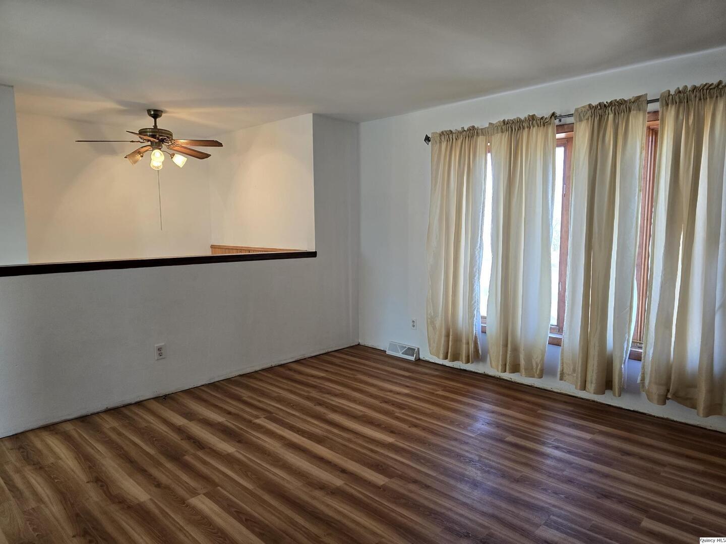 305 East 3rd Street Bowen, IL 62316 - Photo 3 of 32 a view of a room with a window and a ceiling fan