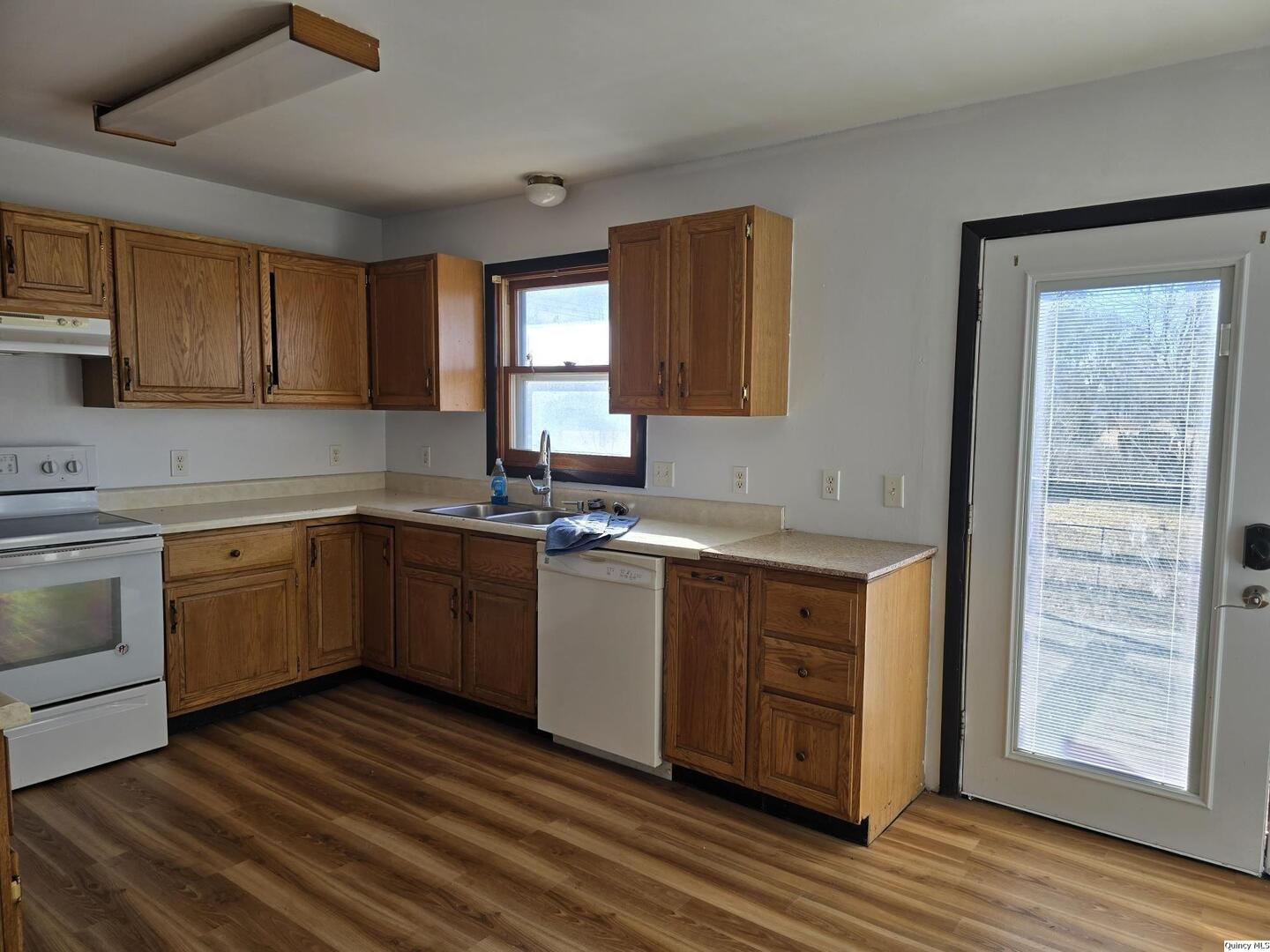 305 East 3rd Street Bowen, IL 62316 - Photo 5 of 32 a kitchen with a sink cabinets stainless steel appliances and a window