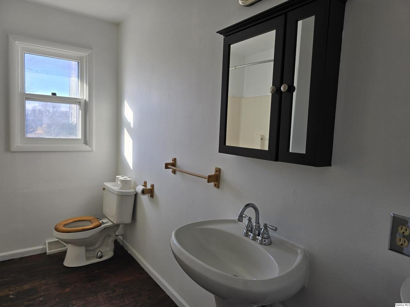 305 East 3rd Street Bowen, IL 62316 - Photo 9 of 32 a bathroom with a toilet sink and mirror