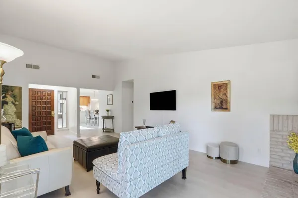 a bedroom with a bed and a flat tv screen on the dresser