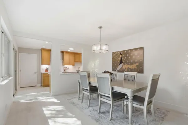 a view of a dining room with furniture and chandelier