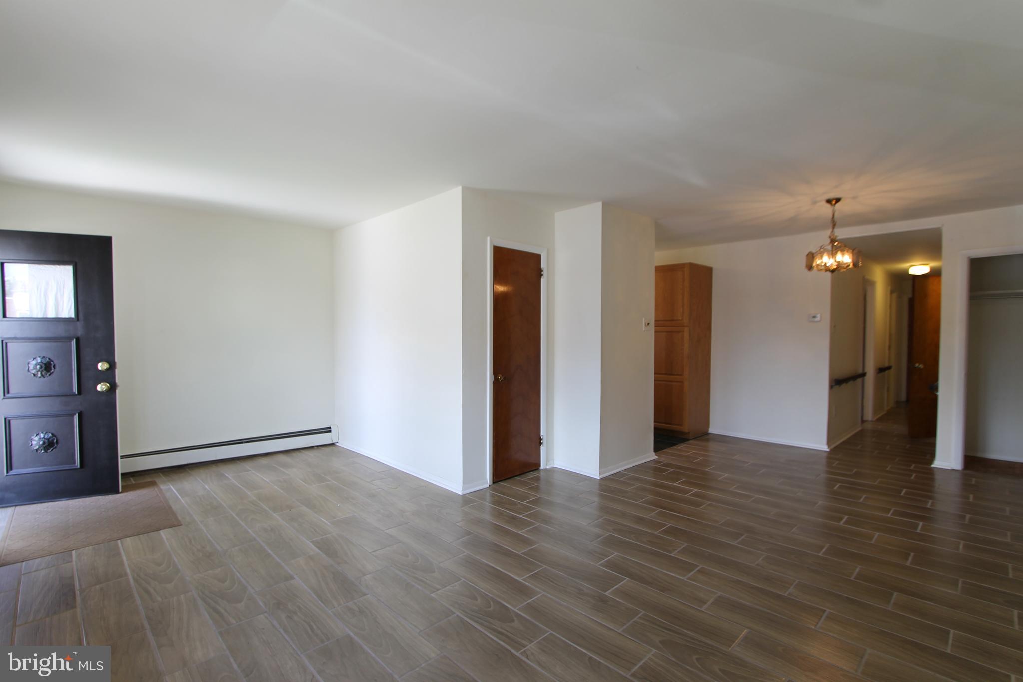 8244 Woolston Avenue Philadelphia, PA 19150 - Photo 11 of 19 a view of a big room with wooden floor and windows