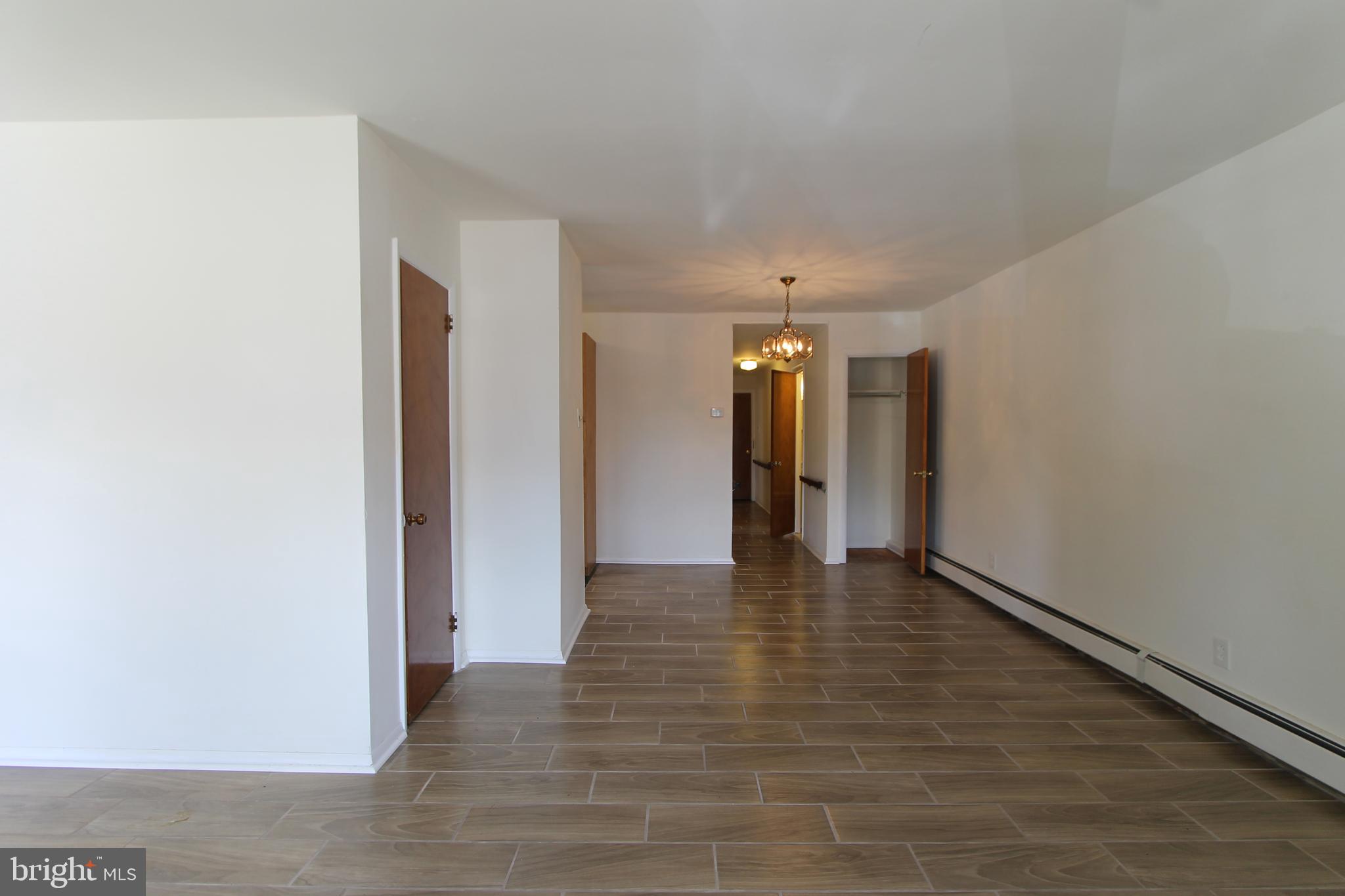 8244 Woolston Avenue Philadelphia, PA 19150 - Photo 12 of 19 a view of an empty room and wooden floor