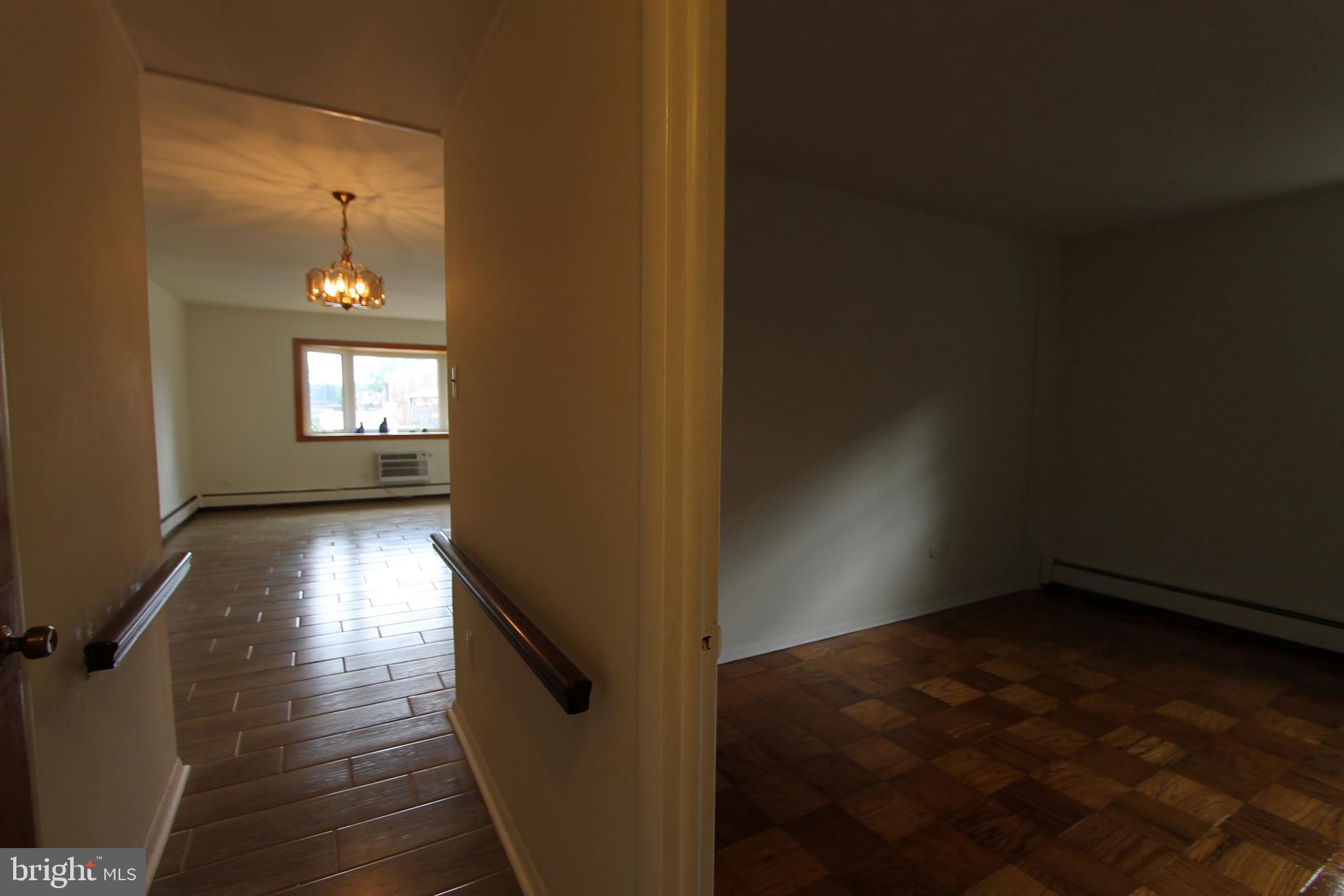 8244 Woolston Avenue Philadelphia, PA 19150 - Photo 19 of 19 wooden floor in an empty room with a window