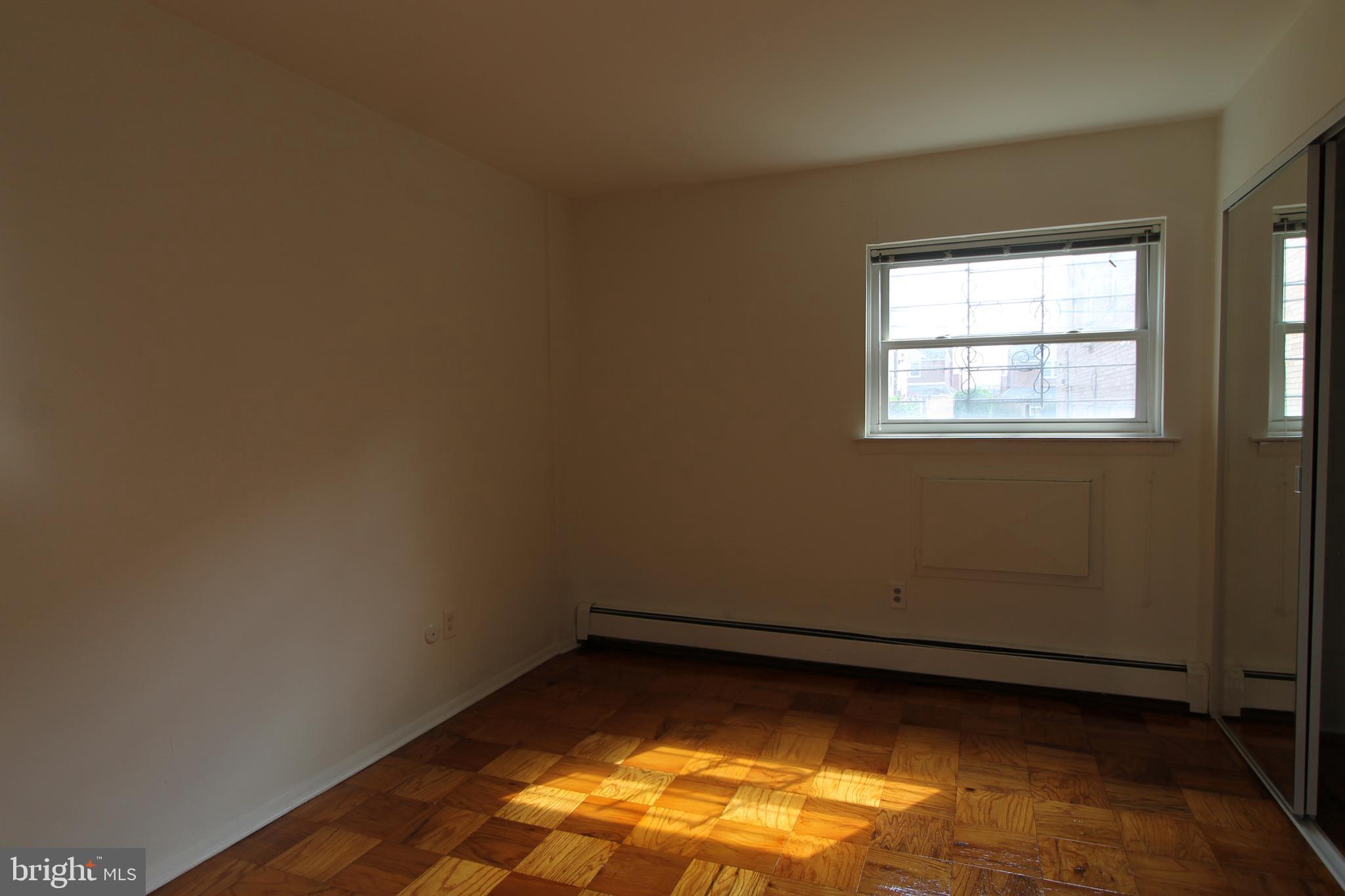 8244 Woolston Avenue Philadelphia, PA 19150 - Photo 2 of 19 an empty room with a window