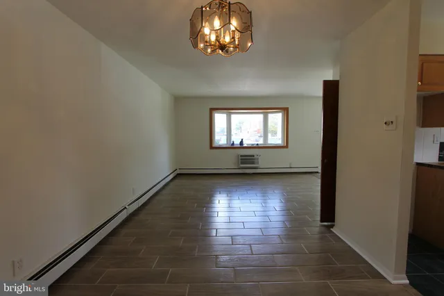 a kitchen with stainless steel appliances granite countertop a refrigerator stove top oven and cabinets with wooden floor