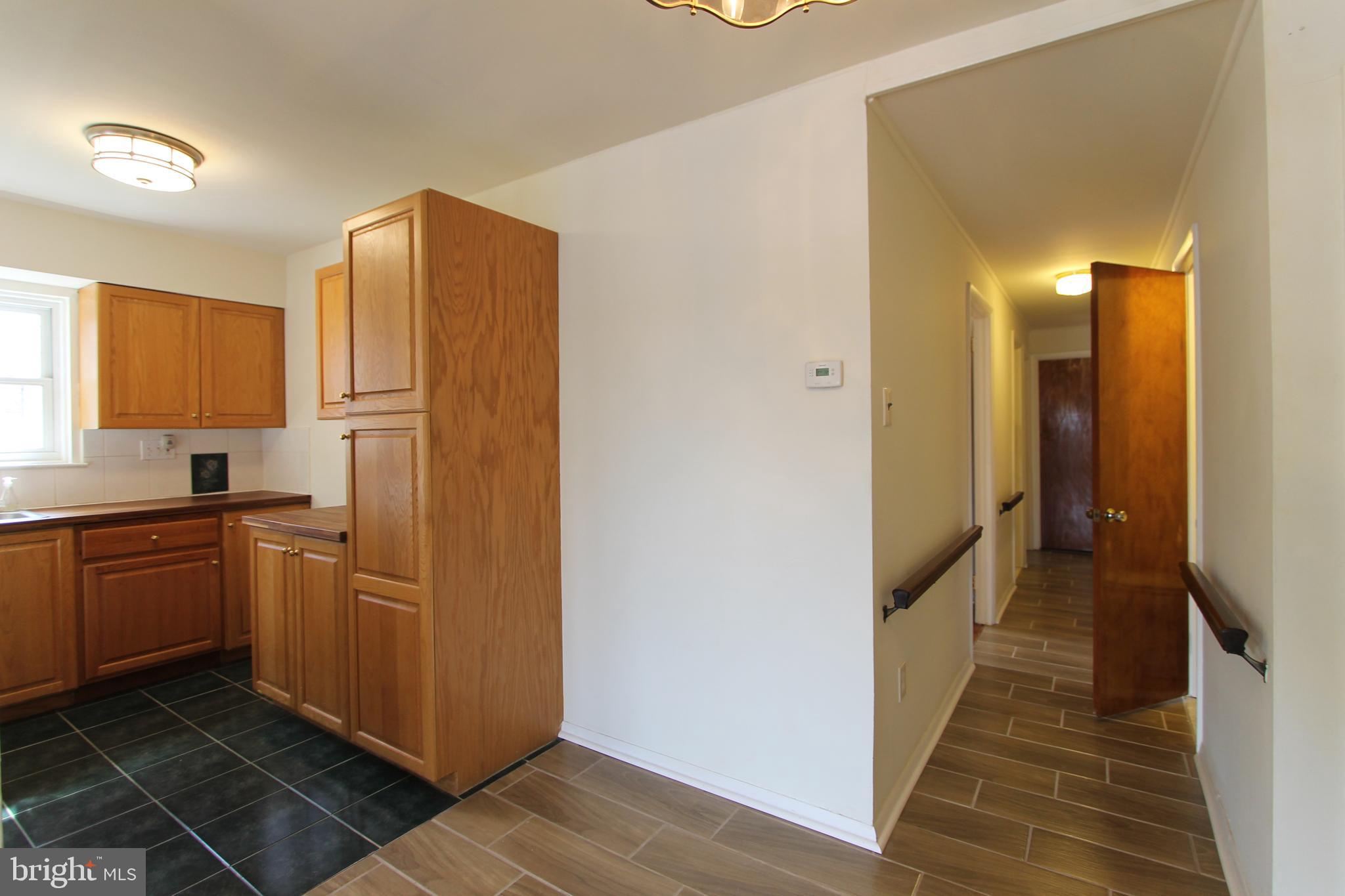 8244 Woolston Avenue Philadelphia, PA 19150 - Photo 10 of 19 a kitchen with stainless steel appliances granite countertop a refrigerator and a sink