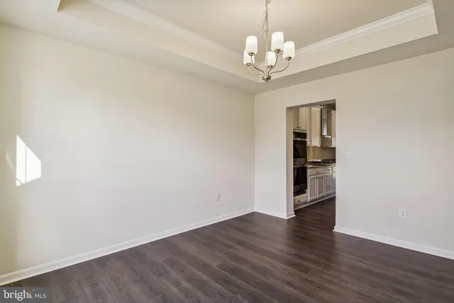 a view of a big room with wooden floor and windows