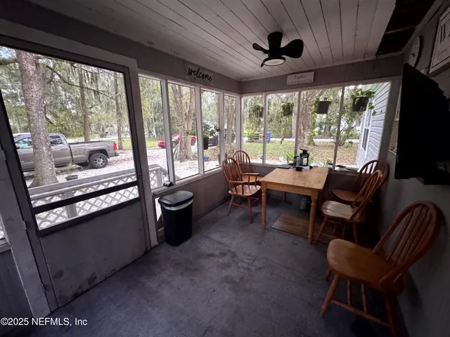 a living room with furniture and a floor to ceiling window
