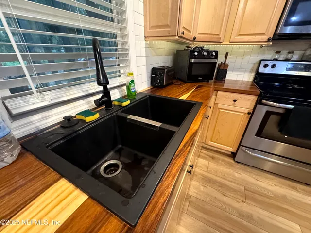 a stove top oven sitting inside of a kitchen