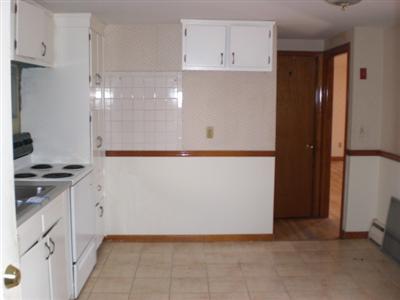 414 Old Stage Road Centerville, MA 02632 - Photo 9 of 10 a kitchen with white cabinets and white appliances