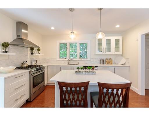 110 Albion Road Wellesley, MA 02481 - Photo 11 of 17 a kitchen with a stove a sink a dining table and chairs