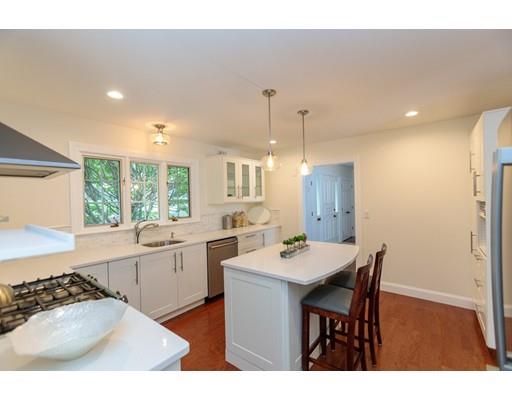 110 Albion Road Wellesley, MA 02481 - Photo 14 of 17 a kitchen with a dining table chairs and white cabinets