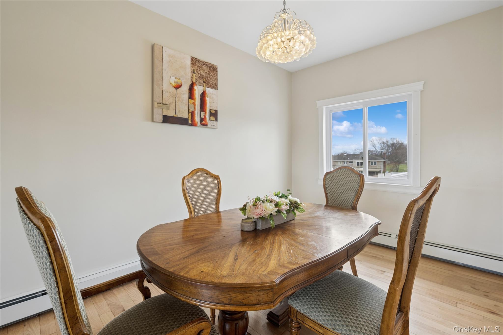40 Scholar Lane Commack, NY 11725 - Photo 18 of 49 a view of a dining room with furniture wooden floor and a chandelier