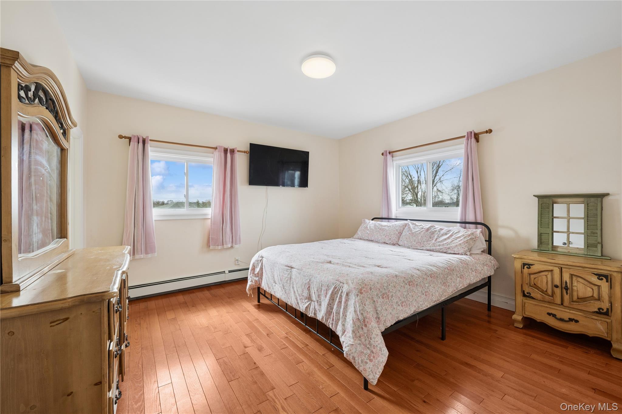 40 Scholar Lane Commack, NY 11725 - Photo 19 of 49 a bedroom with a large bed and a window