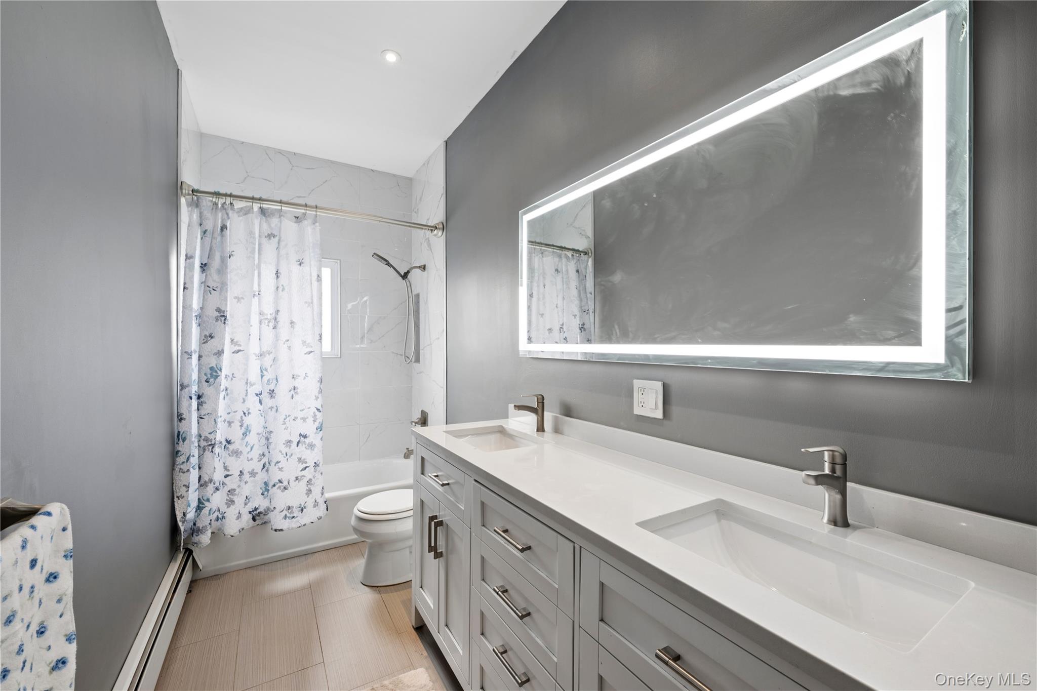 40 Scholar Lane Commack, NY 11725 - Photo 20 of 49 a bathroom with double vanity sink a mirror and a shower