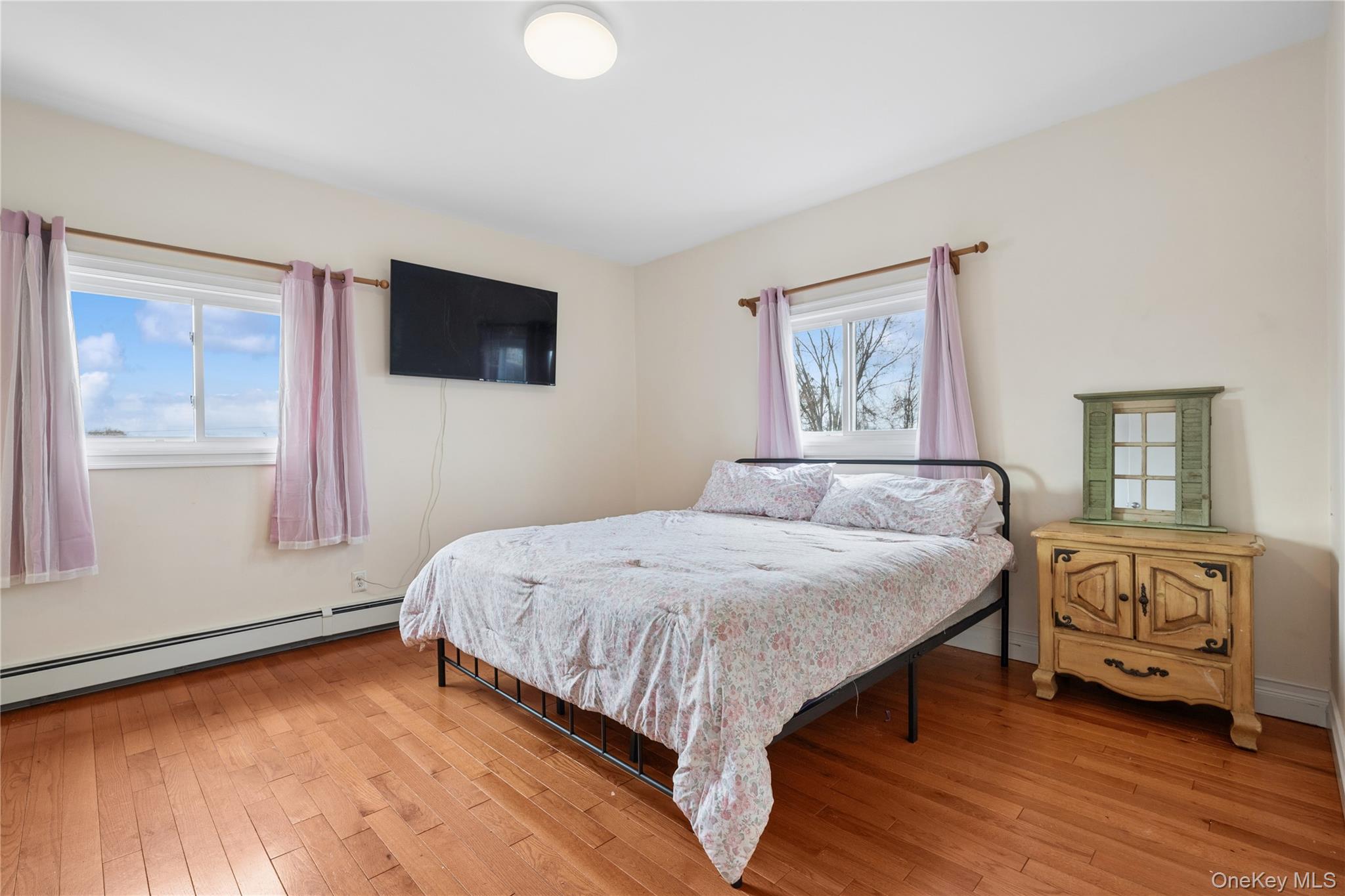 40 Scholar Lane Commack, NY 11725 - Photo 22 of 49 a bedroom with a bed a mirror and a window