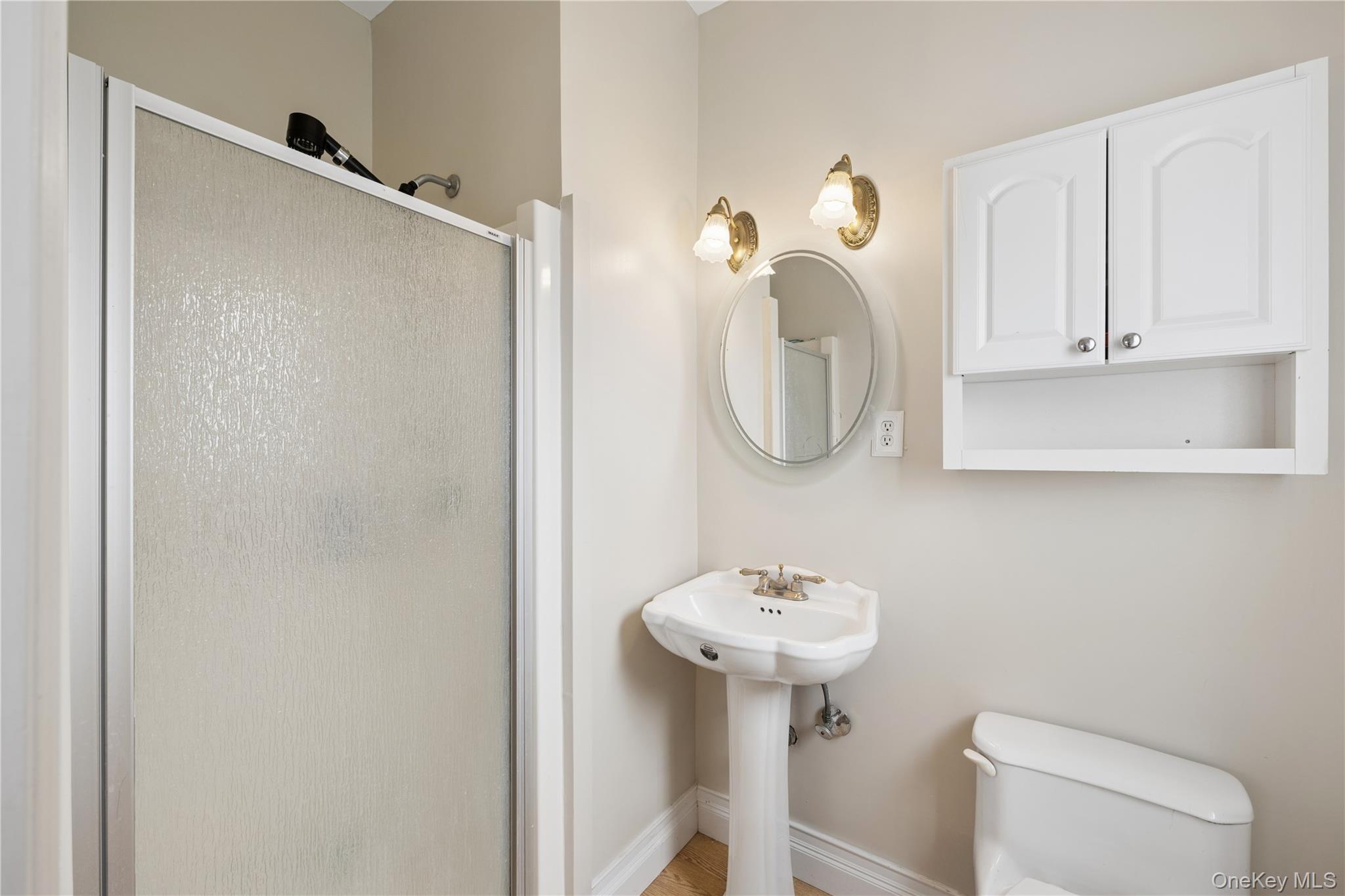 40 Scholar Lane Commack, NY 11725 - Photo 23 of 49 a bathroom with a sink a toilet and a mirror