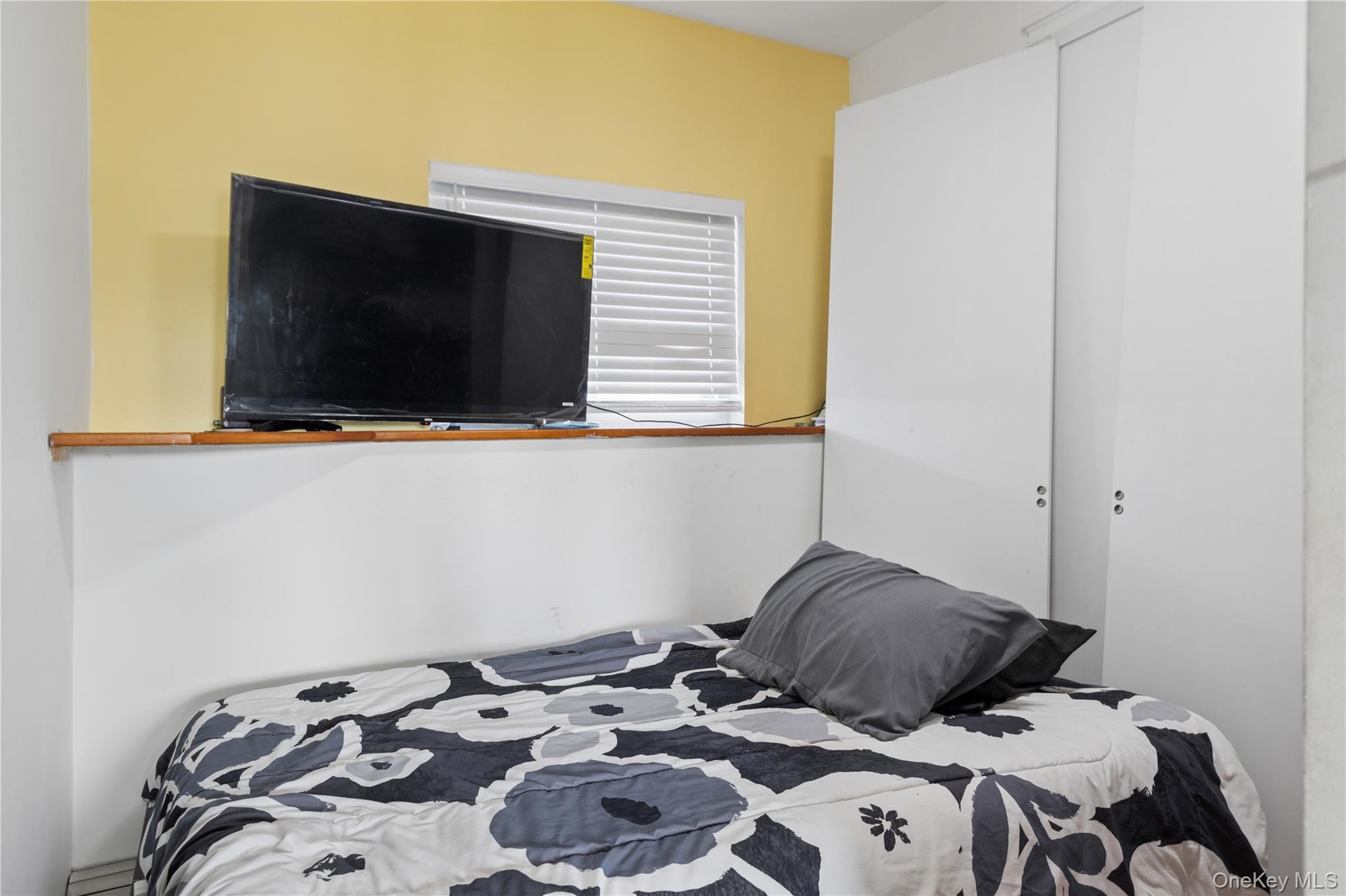 40 Scholar Lane Commack, NY 11725 - Photo 30 of 49 a bedroom with a bed and flat screen tv