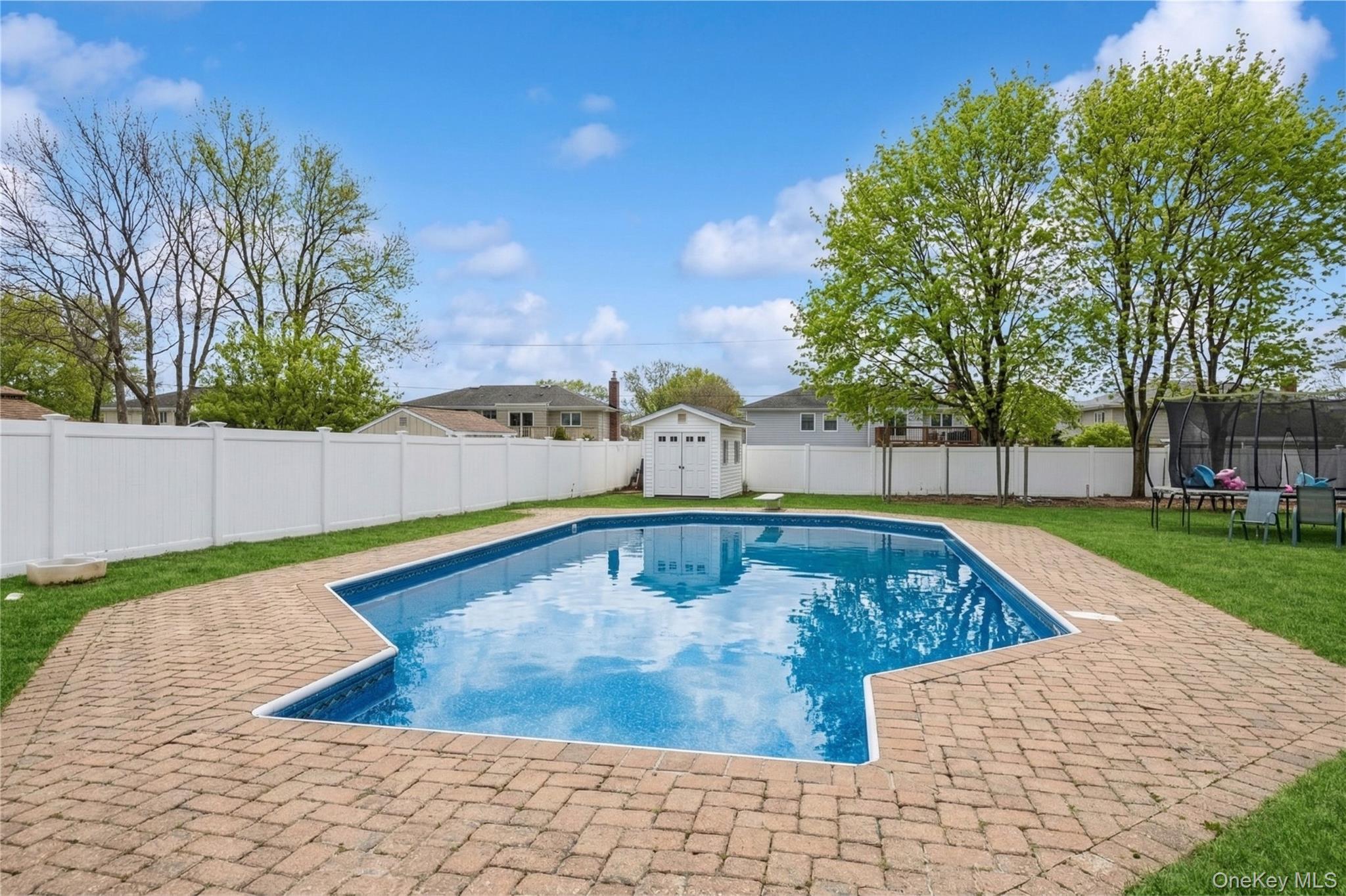 40 Scholar Lane Commack, NY 11725 - Photo 39 of 49 a view of a swimming pool with a yard