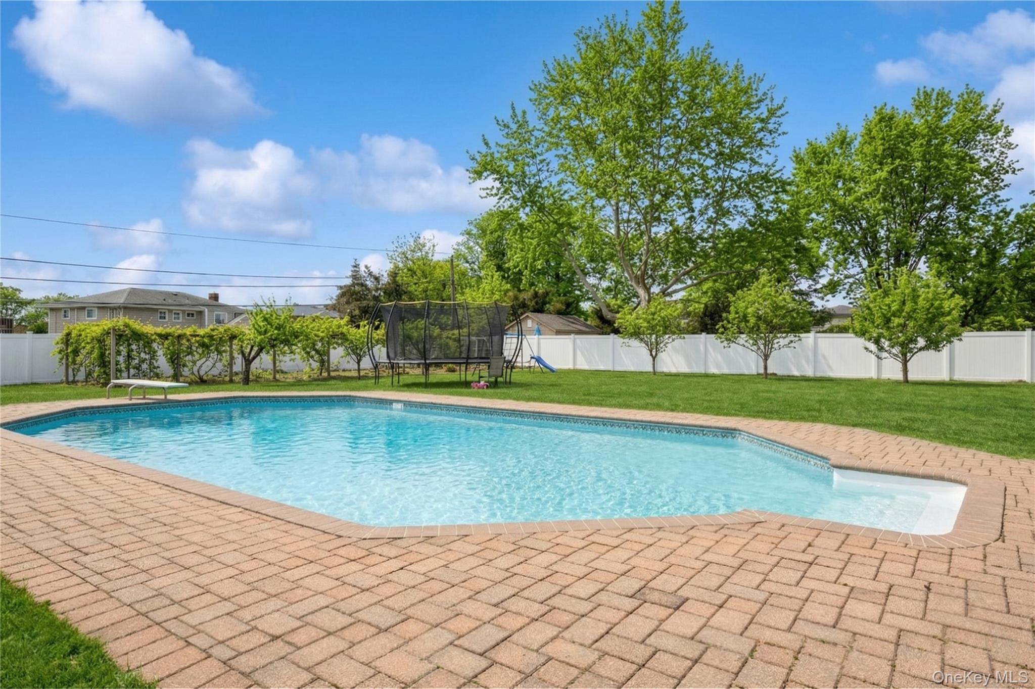 40 Scholar Lane Commack, NY 11725 - Photo 40 of 49 a view of a swimming pool with an outdoor space and seating area