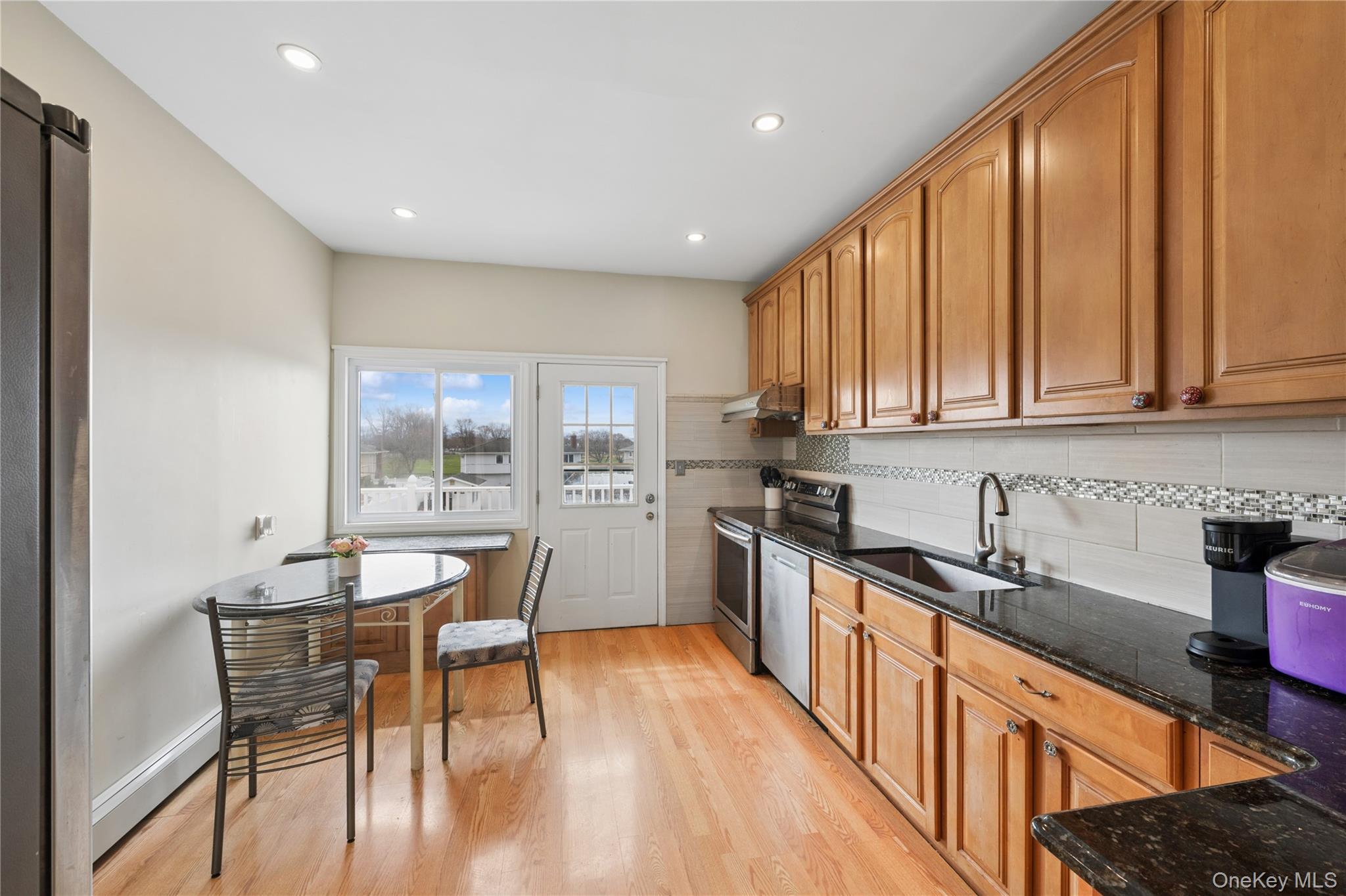40 Scholar Lane Commack, NY 11725 - Photo 10 of 49 a kitchen with stainless steel appliances granite countertop sink stove top oven and cabinets