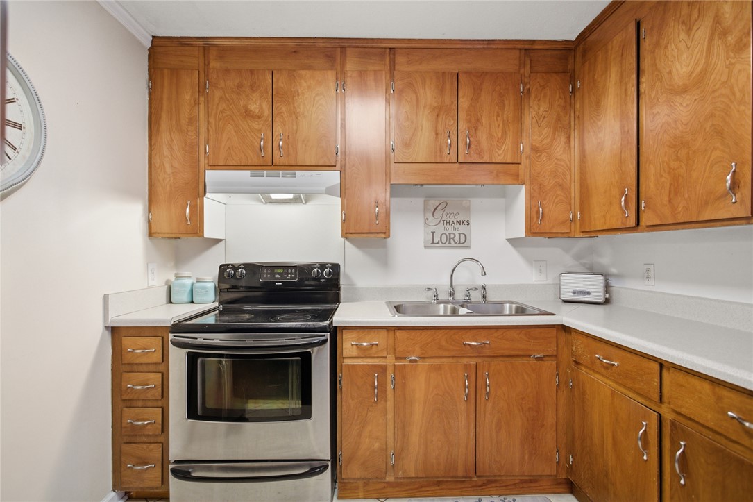 108 Hodge Street Abbeville, SC 29620 - Photo 7 of 39 Functional kitchen featuring abundant wood cabinetry and essential cooking appliances.