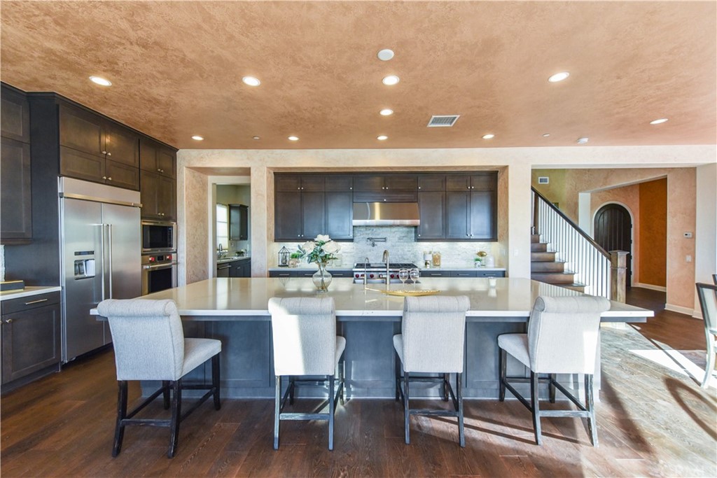 323 Via Pamplona San Clemente, CA 92672 - Photo 2 of 74 a kitchen with a dining table chairs and wooden floor