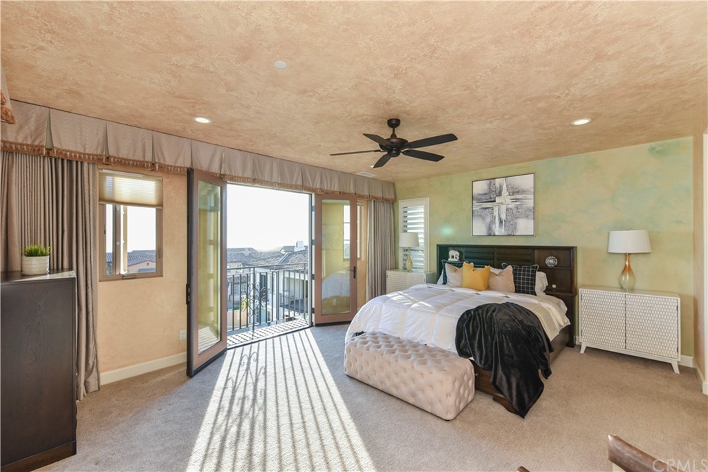 323 Via Pamplona San Clemente, CA 92672 - Photo 28 of 74 a bedroom with a large bed and a chandelier