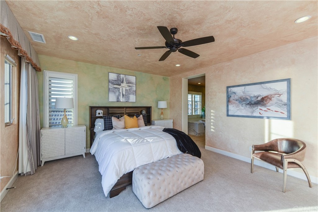 323 Via Pamplona San Clemente, CA 92672 - Photo 29 of 74 a bedroom with a bed and a chandelier