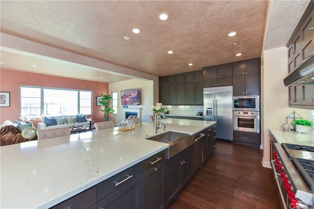 323 Via Pamplona San Clemente, CA 92672 - Photo 4 of 74 a kitchen with stainless steel appliances granite countertop a lot of counter space and wooden floors