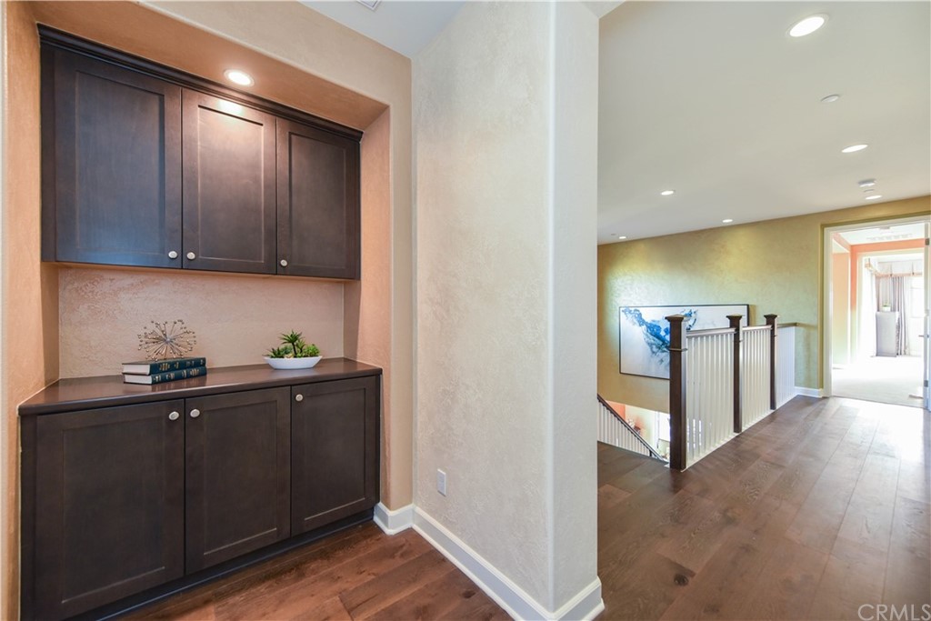 323 Via Pamplona San Clemente, CA 92672 - Photo 45 of 74 a view of a hallway with wooden floor and cabinets