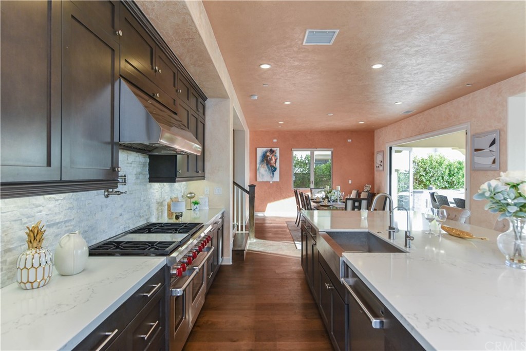 323 Via Pamplona San Clemente, CA 92672 - Photo 5 of 74 a kitchen with stainless steel appliances a sink stove and cabinets