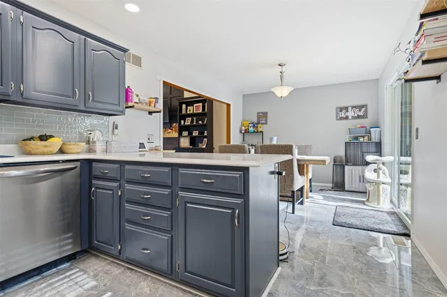 a kitchen with stainless steel appliances granite countertop a sink stove and microwave