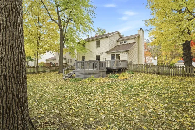 a backyard of a house with table and chairs