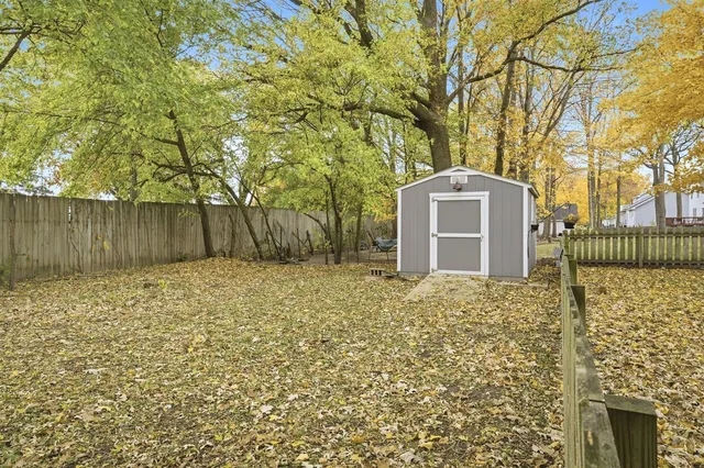a living room with furniture a fireplace and a large window
